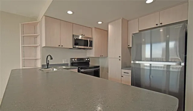 a kitchen with refrigerator and cabinets