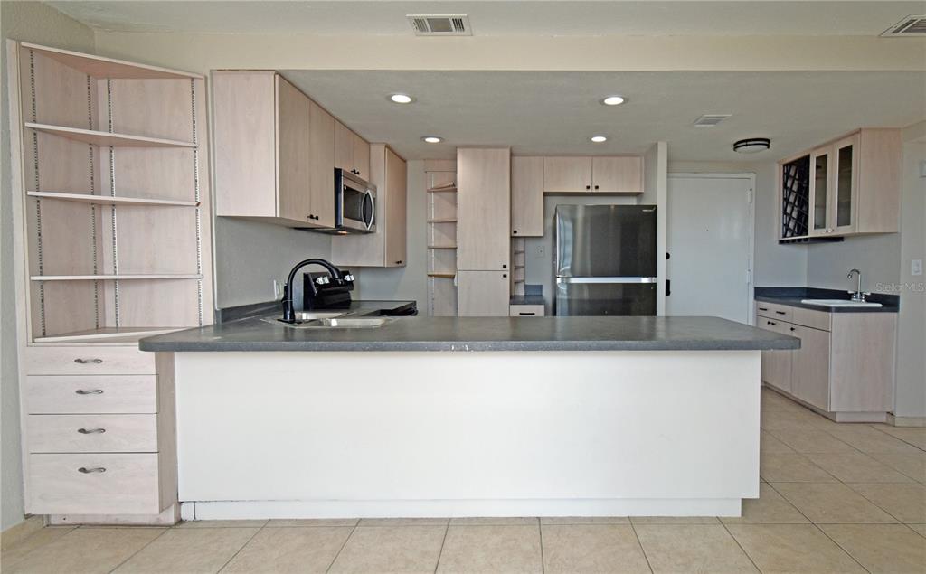 4015 Bayshore Boulevard, Unit 17F Tampa, FL 33611 - Photo 19 of 32 a kitchen with stainless steel appliances granite countertop a sink and cabinets