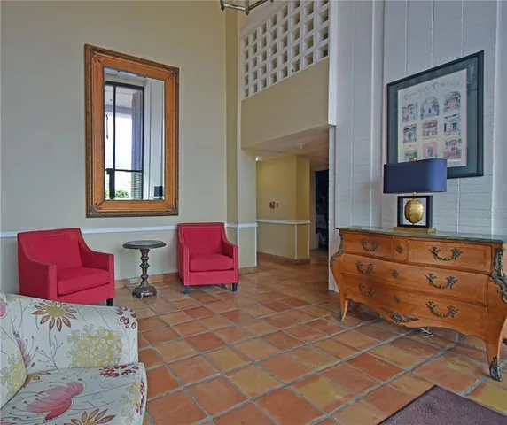 a living room with furniture and a two mirror