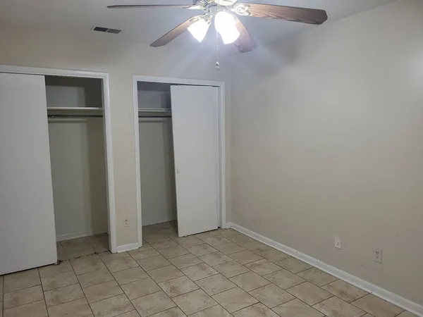 an empty room with closet area
