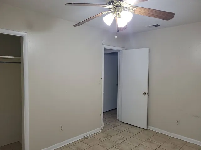 en view of a chandelier fan and entryway
