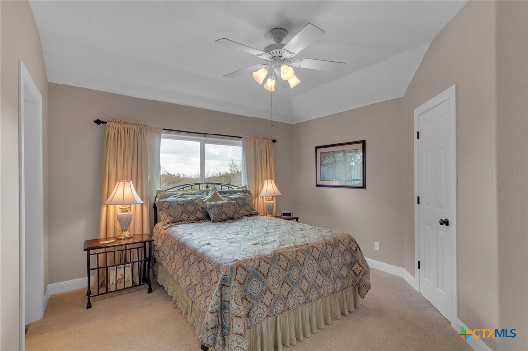 2235 Summit Ridge San Marcos, TX 78666 - Photo 31 of 38 a bedroom with a bed and a chandelier