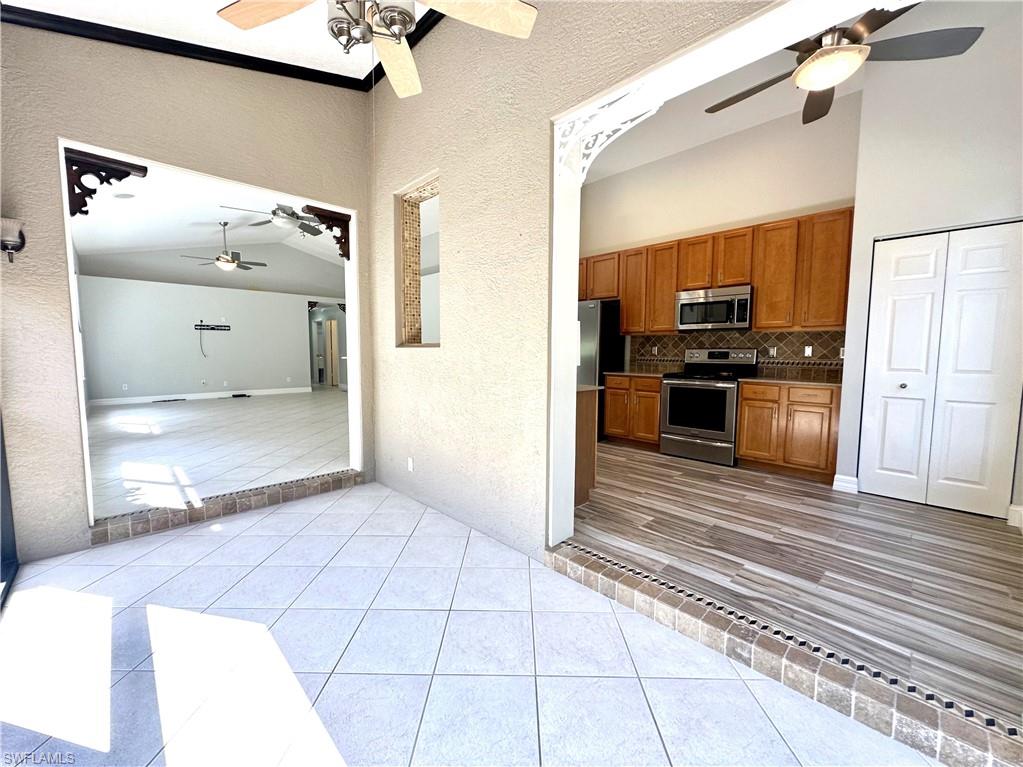 1356 Triandra Lane Naples, FL 34119 - Photo 12 of 38 a view of a hallway with wooden floor and a living room