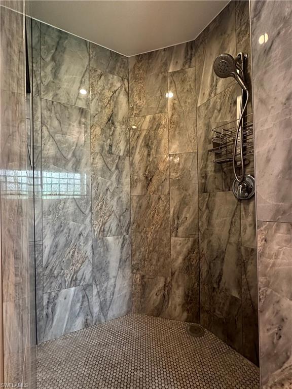 1356 Triandra Lane Naples, FL 34119 - Photo 21 of 38 a bathroom with a shower