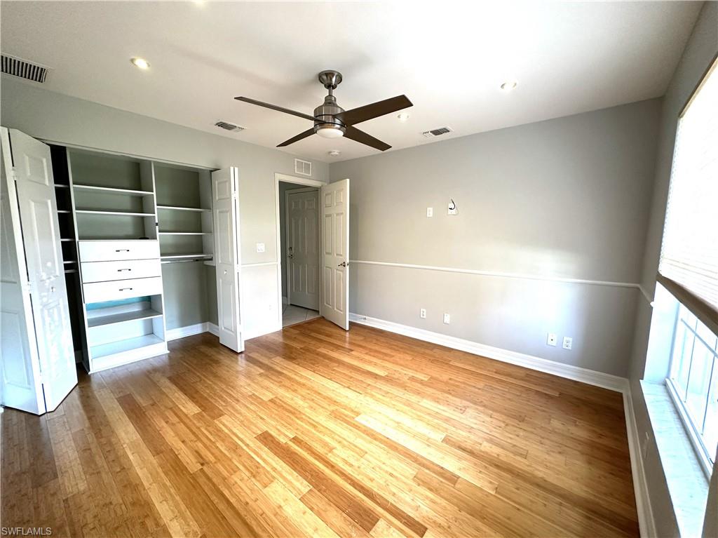 1356 Triandra Lane Naples, FL 34119 - Photo 22 of 38 wooden floor in an empty room with a window