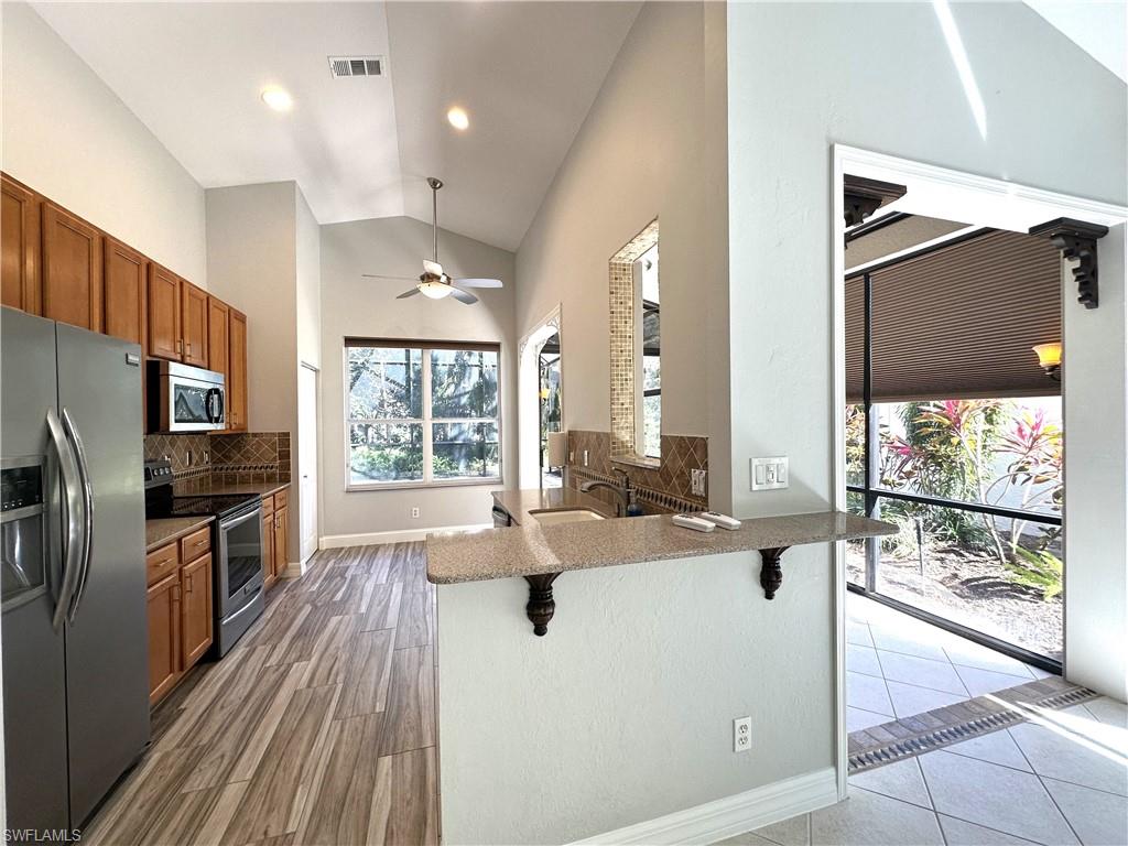 1356 Triandra Lane Naples, FL 34119 - Photo 8 of 38 a large white kitchen with a large window