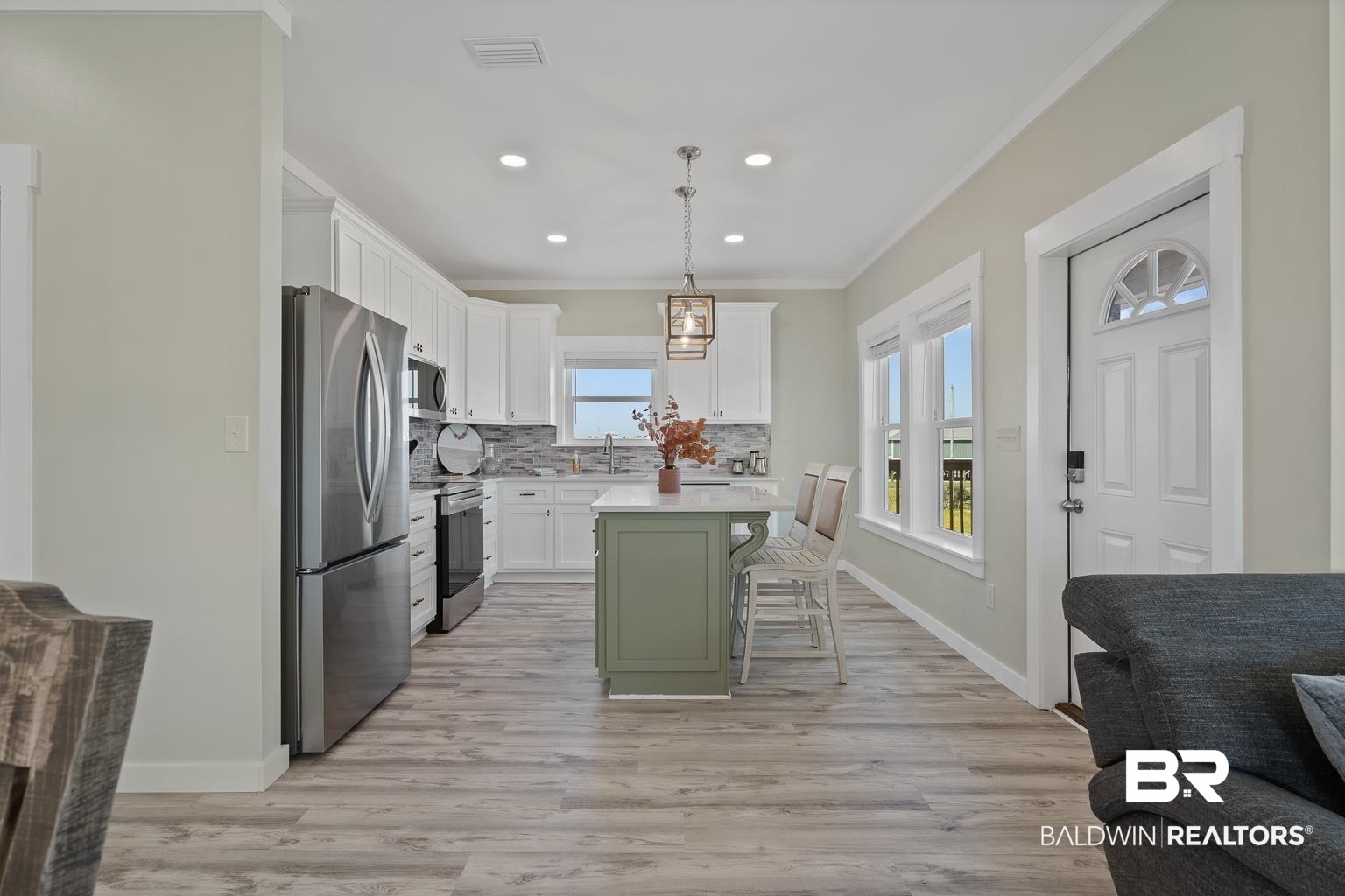 2586 Muscogee Road Gulf Shores, AL 36542 - Photo 10 of 55 Kitchen with decorative light fixtures, stainless steel appliances, a center island, a kitchen bar, and a healthy amount of sunlight