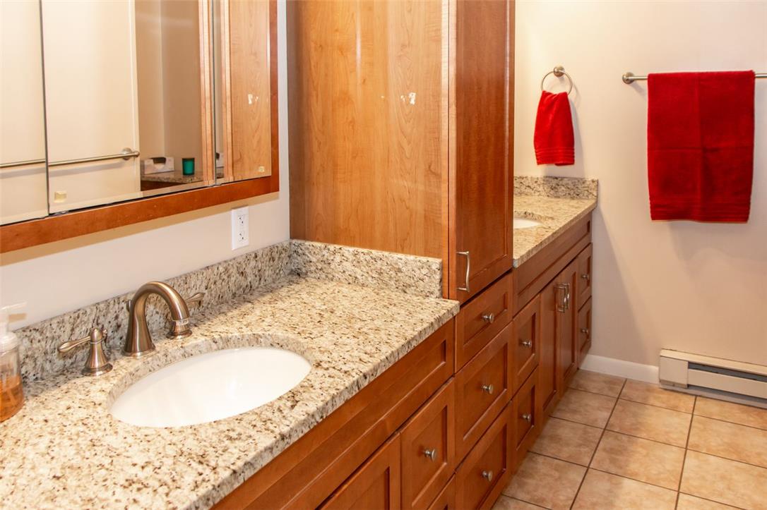 700 Newlins Road East Easton, PA 18040 - Photo 17 of 42 Granite counters and rich wood cabinetry create a functional, stylish bathroom vanity.