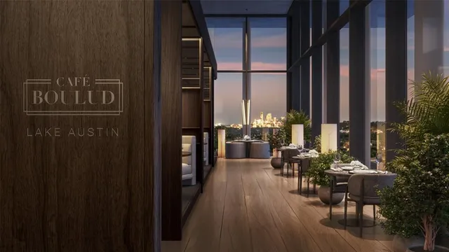 a view of balcony with chairs and potted plants with wooden floor