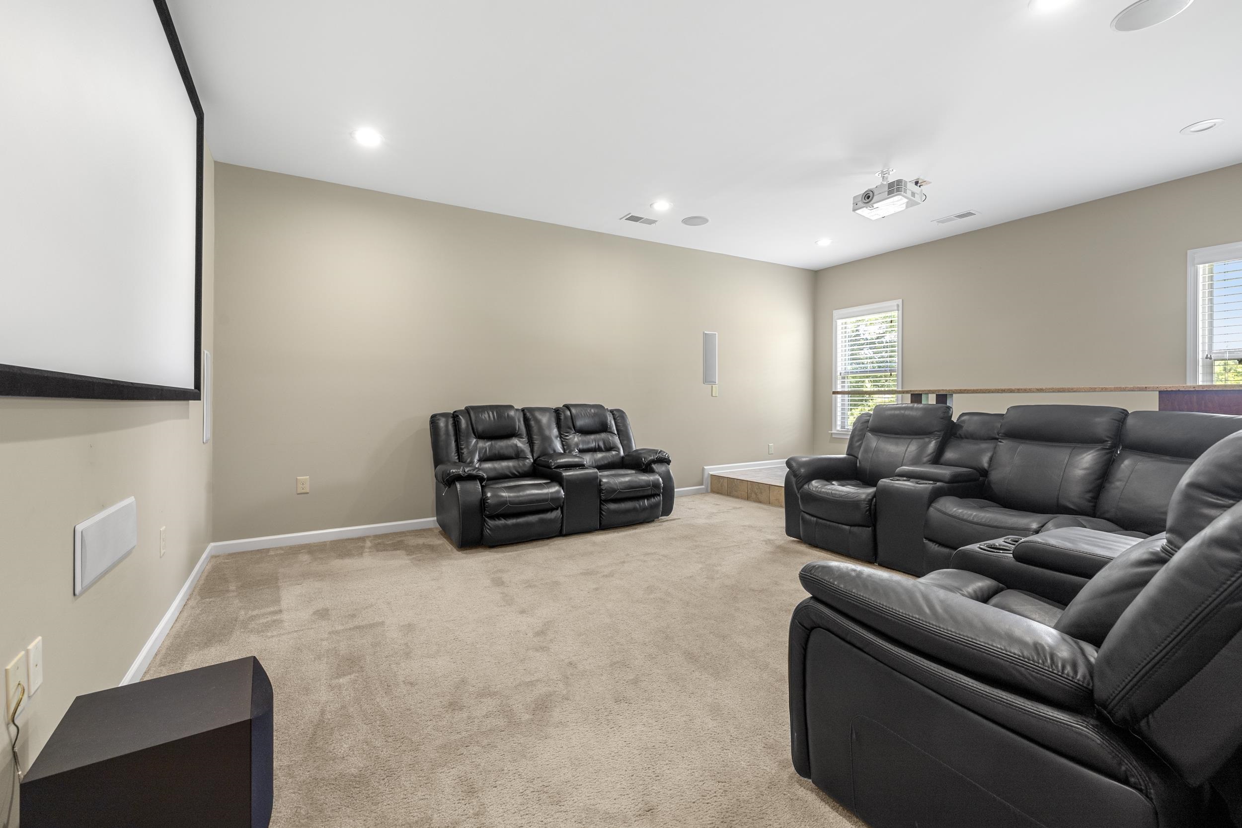 185 Belmont Road Mason, TN 38049 - Photo 9 of 38 Dedicated media room featuring a large projection screen, recessed lighting, and a ceiling-mounted projector