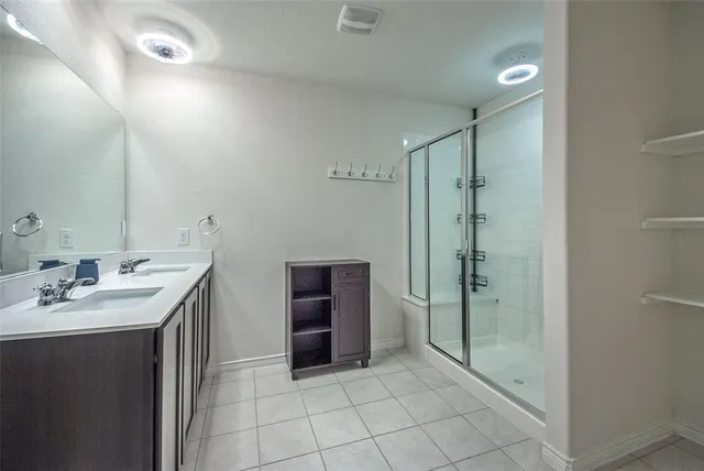 a bathroom with a shower sink and mirror