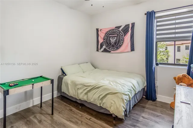 a bedroom with a bed and a painting on the wall