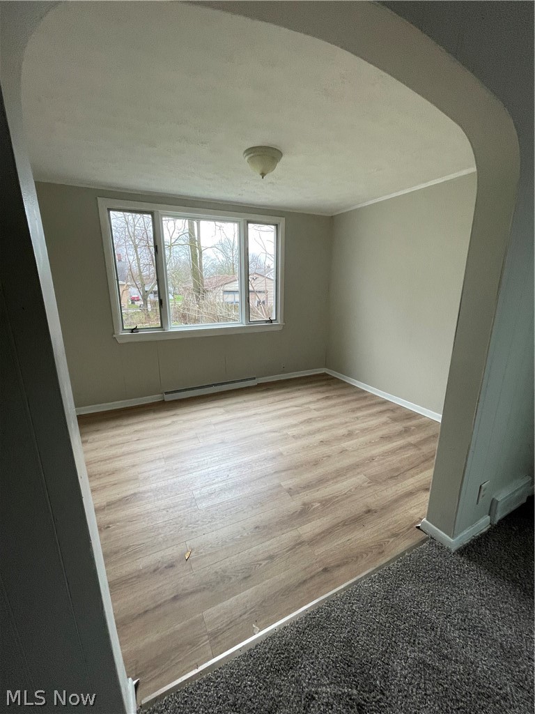 933 Inman Street Akron, OH 44306 - Photo 5 of 25 Unfurnished room with a baseboard heating unit and light hardwood / wood-style flooring
