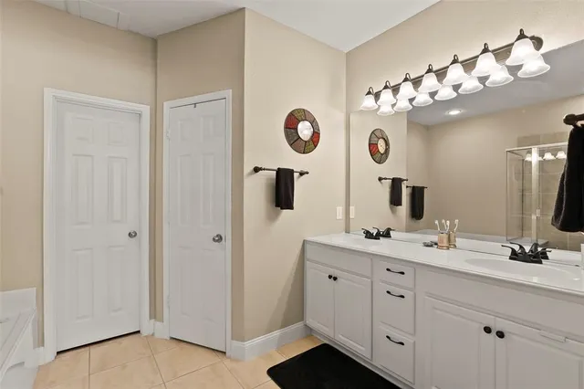 a bathroom with a sink vanity and mirror