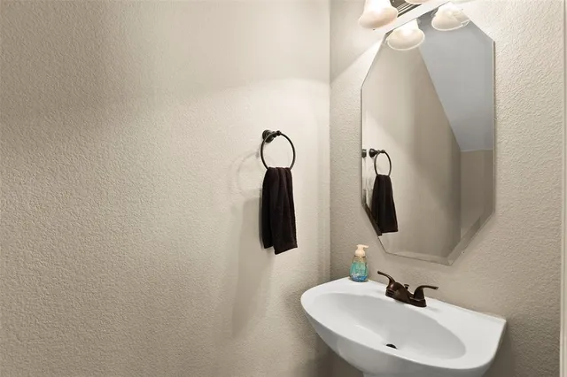 a bathroom with a sink and mirror