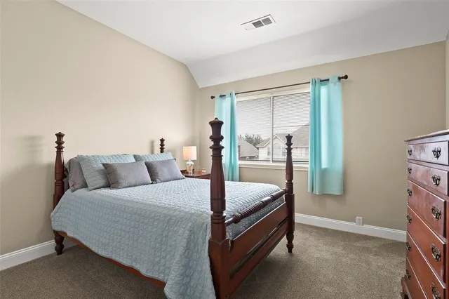 a bed room with a bed and a lamp