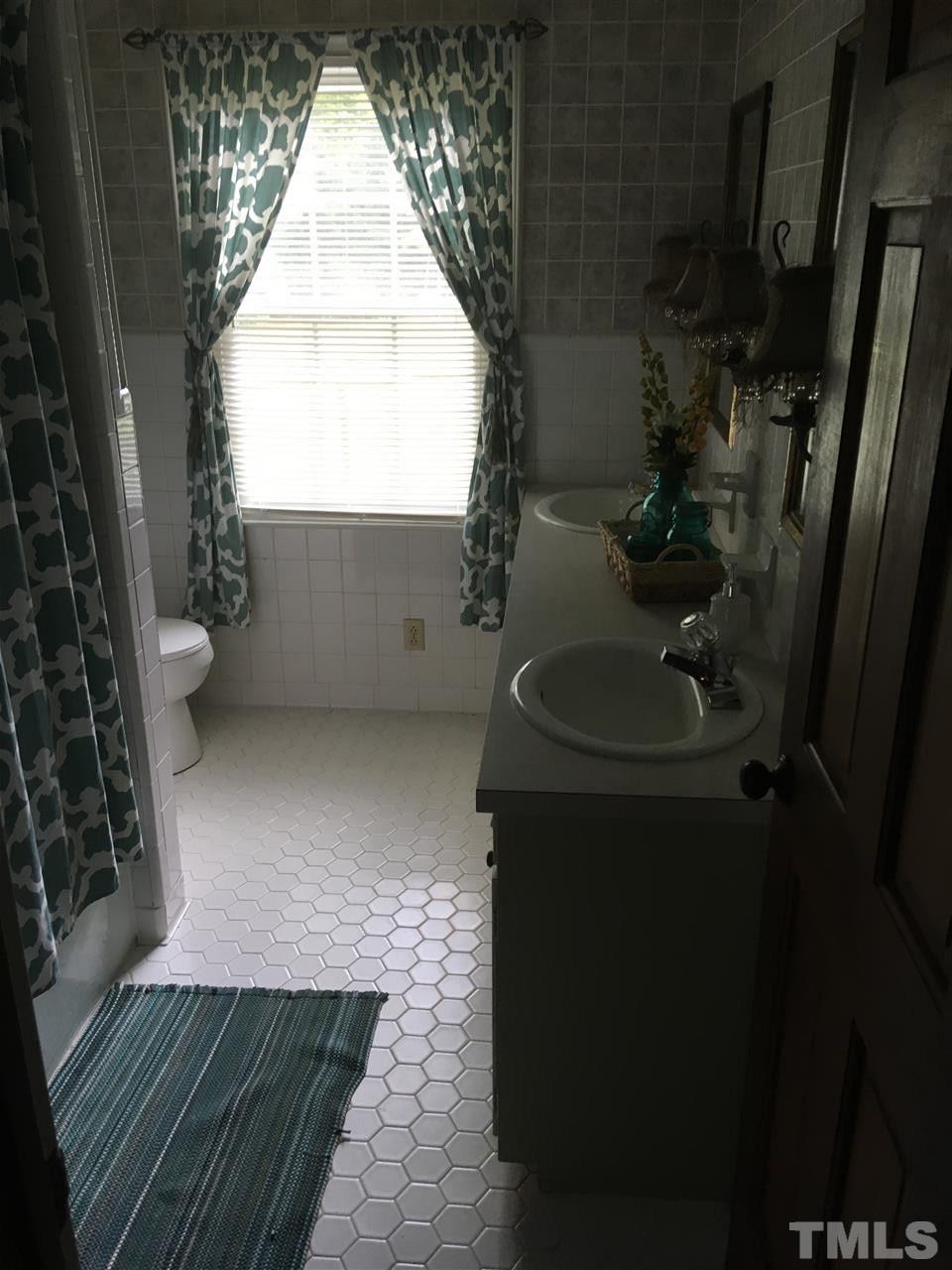 518 Pilot-Riley Road Zebulon, NC 27597 - Photo 21 of 25 a bathroom with a sink and a toilet