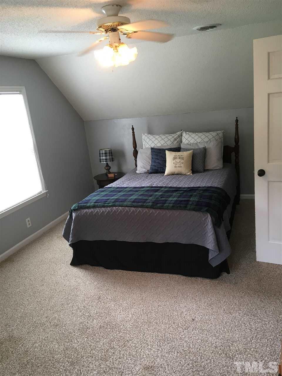518 Pilot-Riley Road Zebulon, NC 27597 - Photo 22 of 25 a bedroom with a bed and window