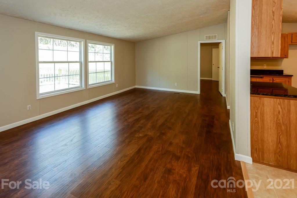 525 Hamilton Road Rutherfordton, NC 28139 - Photo 11 of 39 an empty room with wooden floor and windows