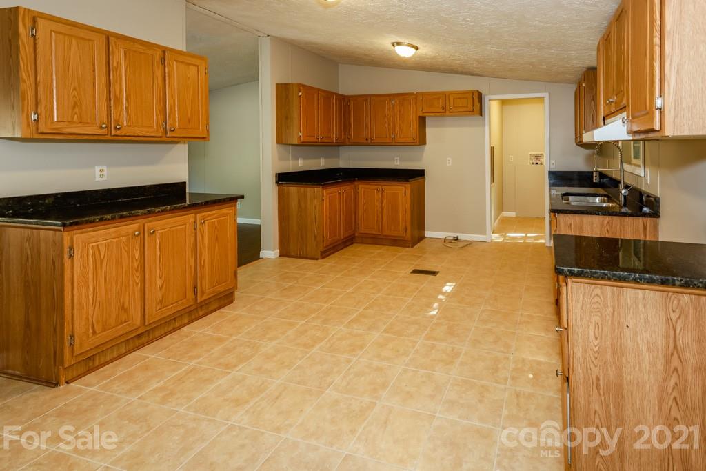 525 Hamilton Road Rutherfordton, NC 28139 - Photo 13 of 39 a kitchen with stainless steel appliances granite countertop a stove a sink and a refrigerator