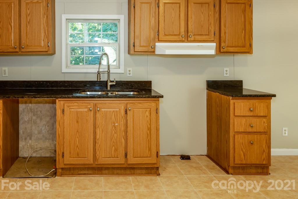 525 Hamilton Road Rutherfordton, NC 28139 - Photo 15 of 39 a kitchen with stainless steel appliances granite countertop cabinets and window