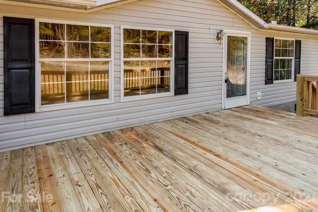 525 Hamilton Road Rutherfordton, NC 28139 - Photo 9 of 39 a view of a house with a barbeque and wooden floor