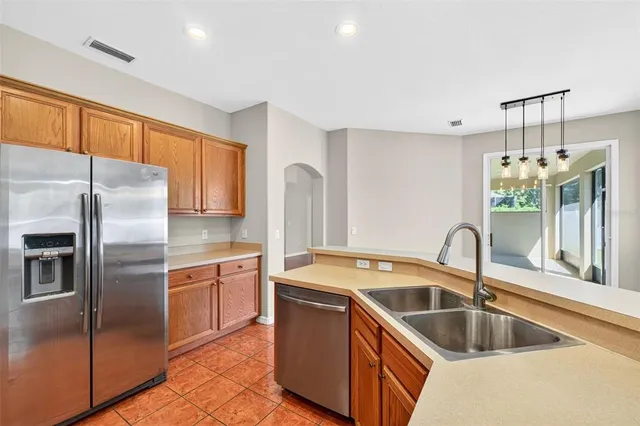 a living room with furniture and a view of kitchen