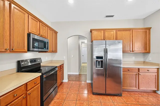 a living room with furniture a flat screen tv and a large window
