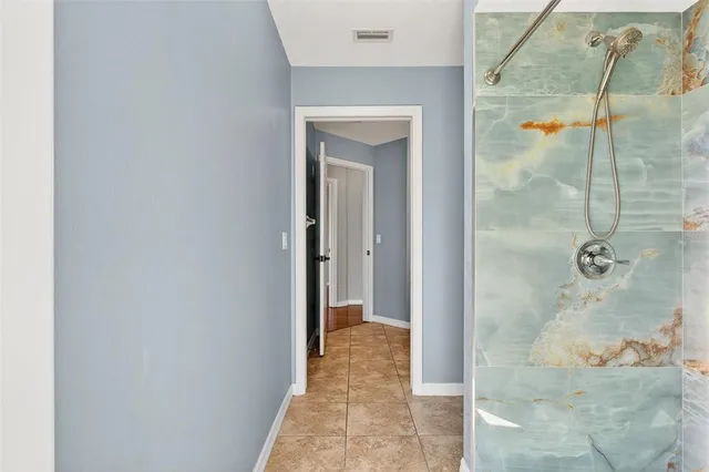 a bathroom with a sink toilet vanity and shower