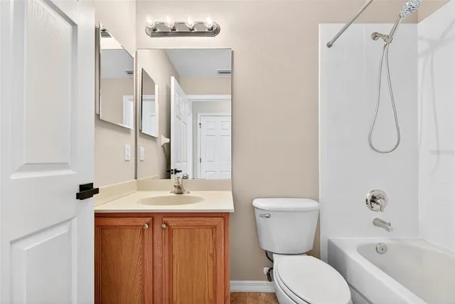 a front view of a house with a yard and potted plants