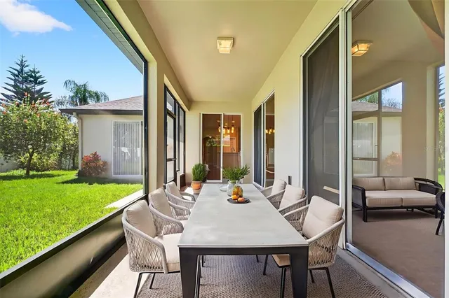 an aerial view of a residential houses with outdoor space and trees