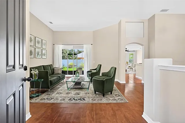 a living room with furniture and a chandelier