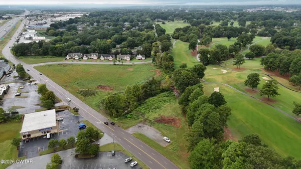 an aerial view of residential houses with outdoor space and river