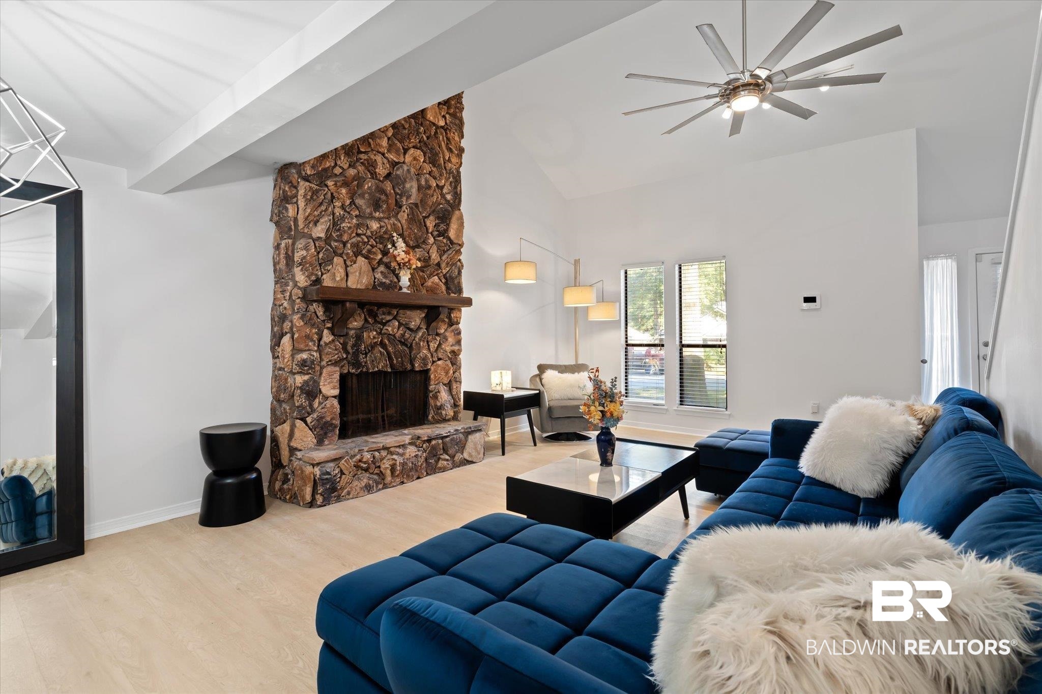 1008 Mcneil Avenue Mobile, AL 36609 - Photo 4 of 20 Living room featuring high vaulted ceiling, a stone fireplace, ceiling fan, light wood-type flooring, and beamed ceiling