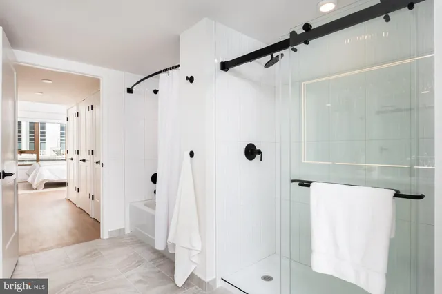 a bedroom with a bed and painting on the wall