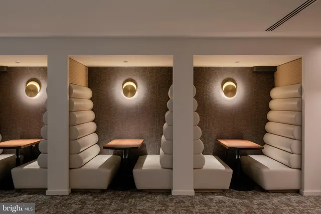 a living room with furniture kitchen view and a large window