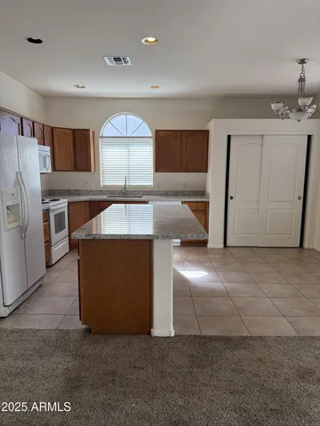 a living room with a couch and a refrigerator