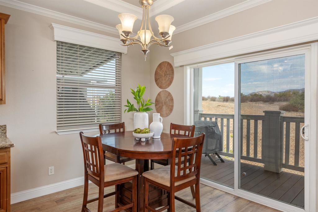 9500 Harritt Road, Unit 29 Lakeside, CA 92040 - Photo 11 of 32 a dining room with furniture a chandelier and wooden floor