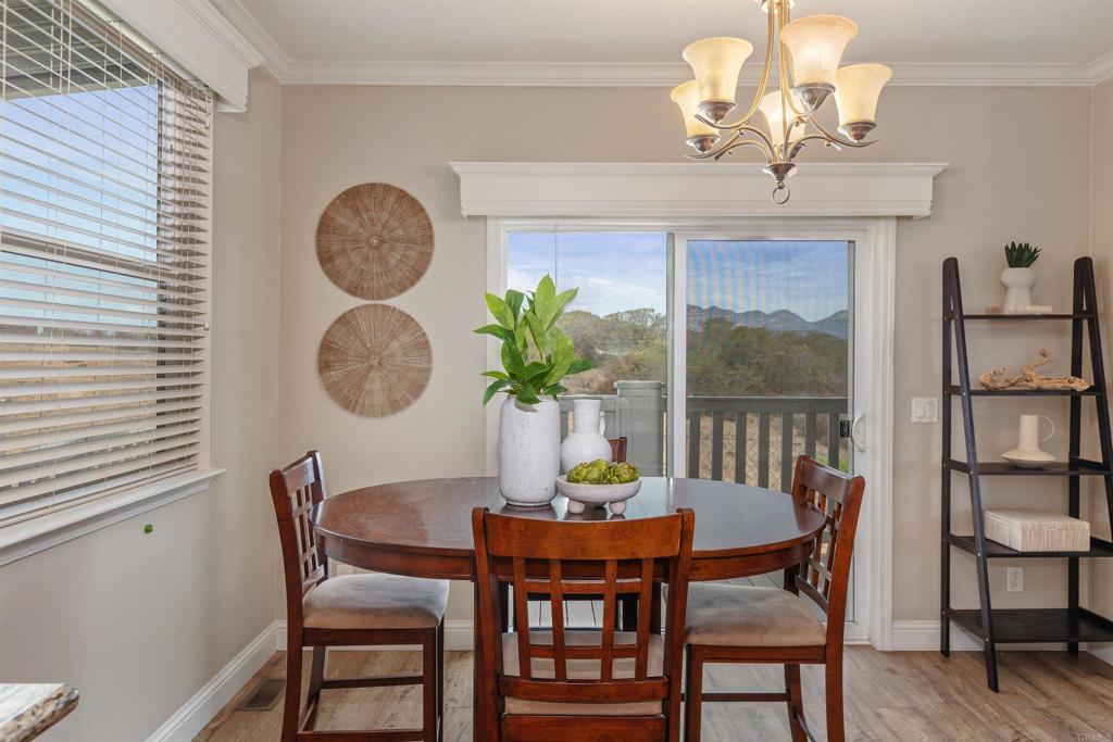 9500 Harritt Road, Unit 29 Lakeside, CA 92040 - Photo 12 of 32 a dining room with furniture a potted plant and a chandelier
