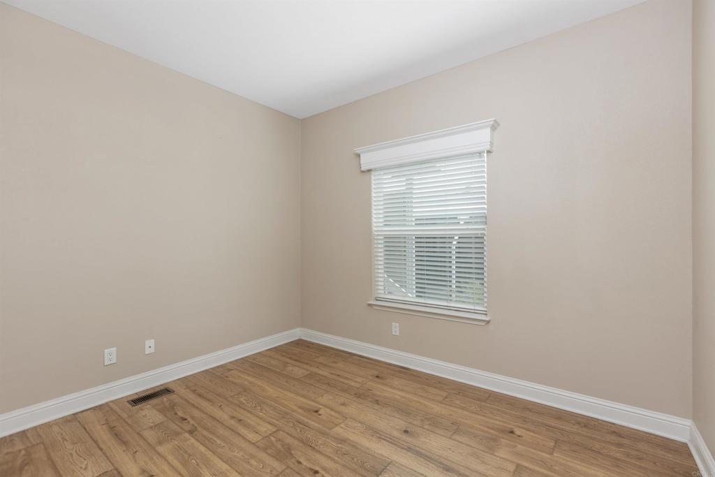 9500 Harritt Road, Unit 29 Lakeside, CA 92040 - Photo 25 of 32 a view of an empty room with wooden floor and a window