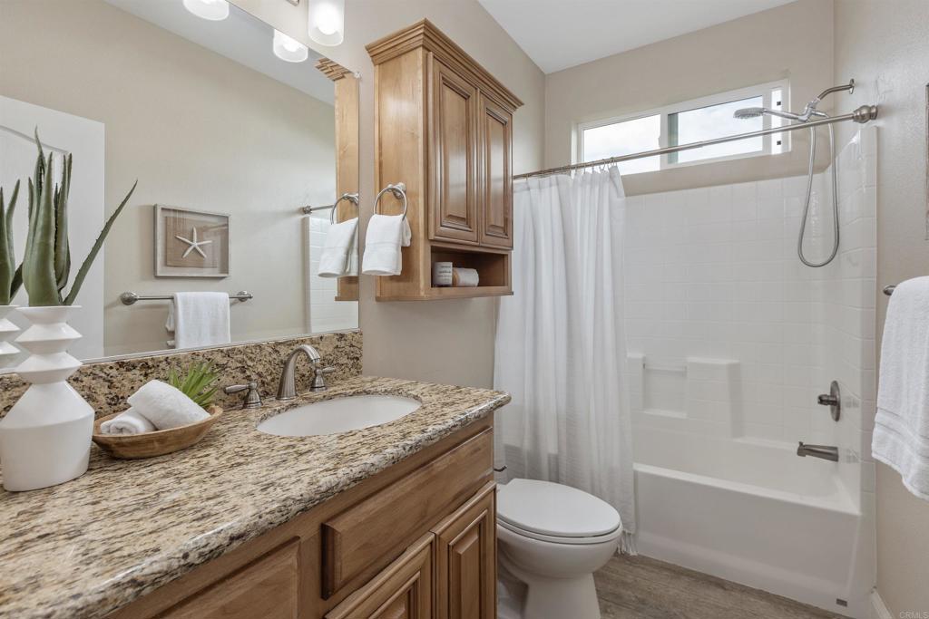 9500 Harritt Road, Unit 29 Lakeside, CA 92040 - Photo 27 of 32 a bathroom with a granite countertop sink toilet and shower