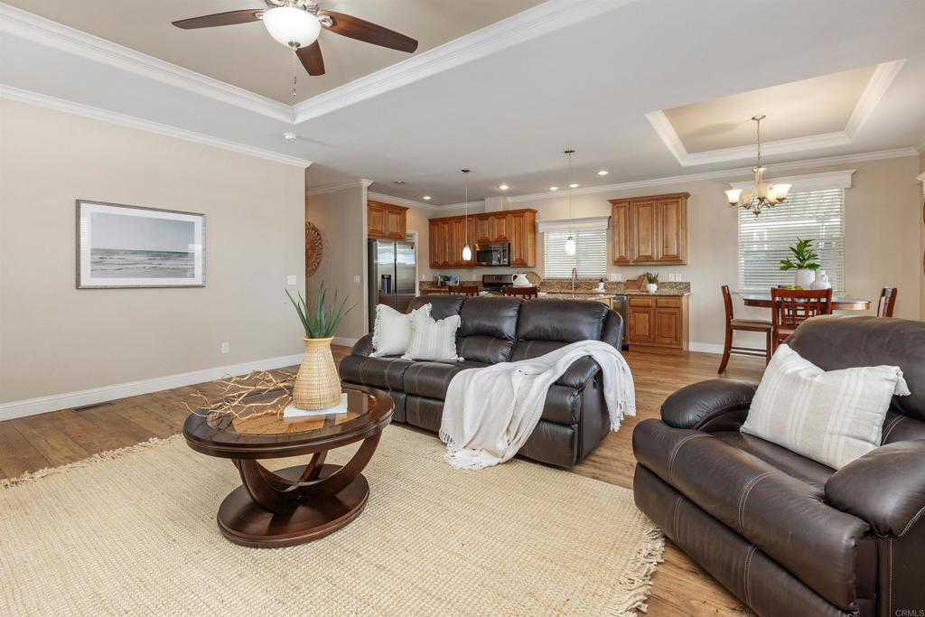 9500 Harritt Road, Unit 29 Lakeside, CA 92040 - Photo 10 of 32 a living room with furniture a rug and a chandelier