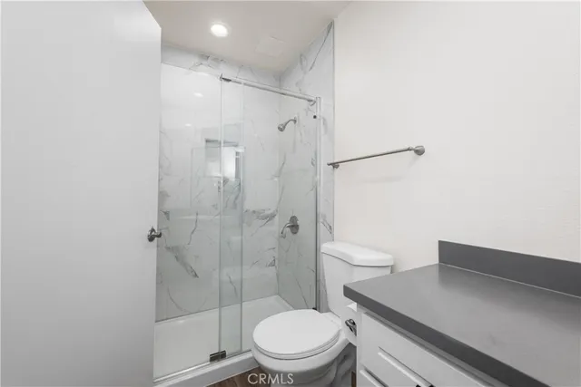 a white toilet sitting next to a bathroom sink