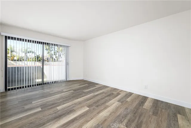 a view of a livingroom with wooden floor and a window