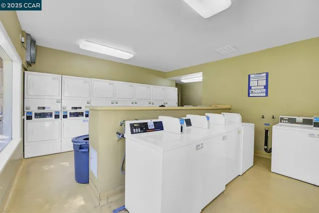 a view of a roof deck with couches and wooden floor
