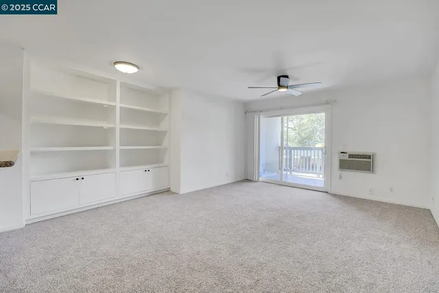 an empty room with a empty space and windows