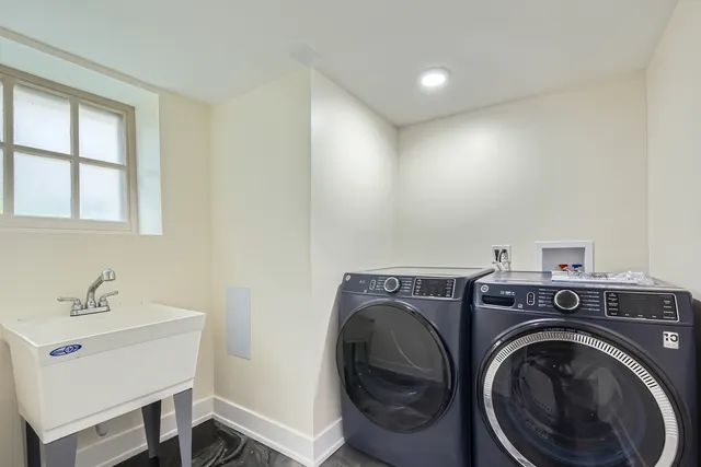 a utility room with sink dryer and washer