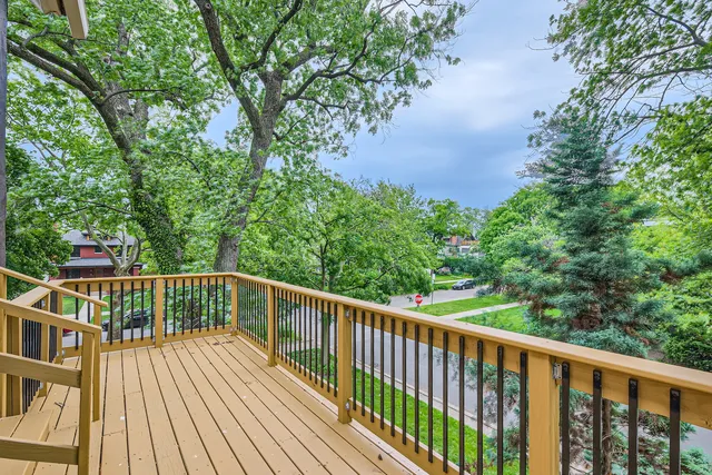 a view of balcony with wooden floor and fence