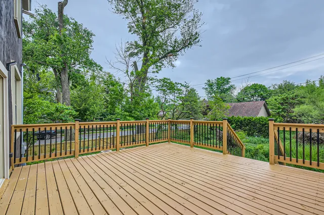 a balcony with wooden floor and fence
