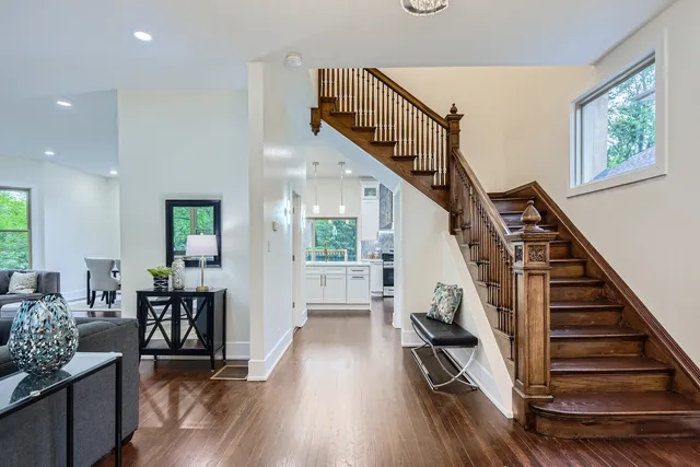 a view of entryway and hall with wooden floor